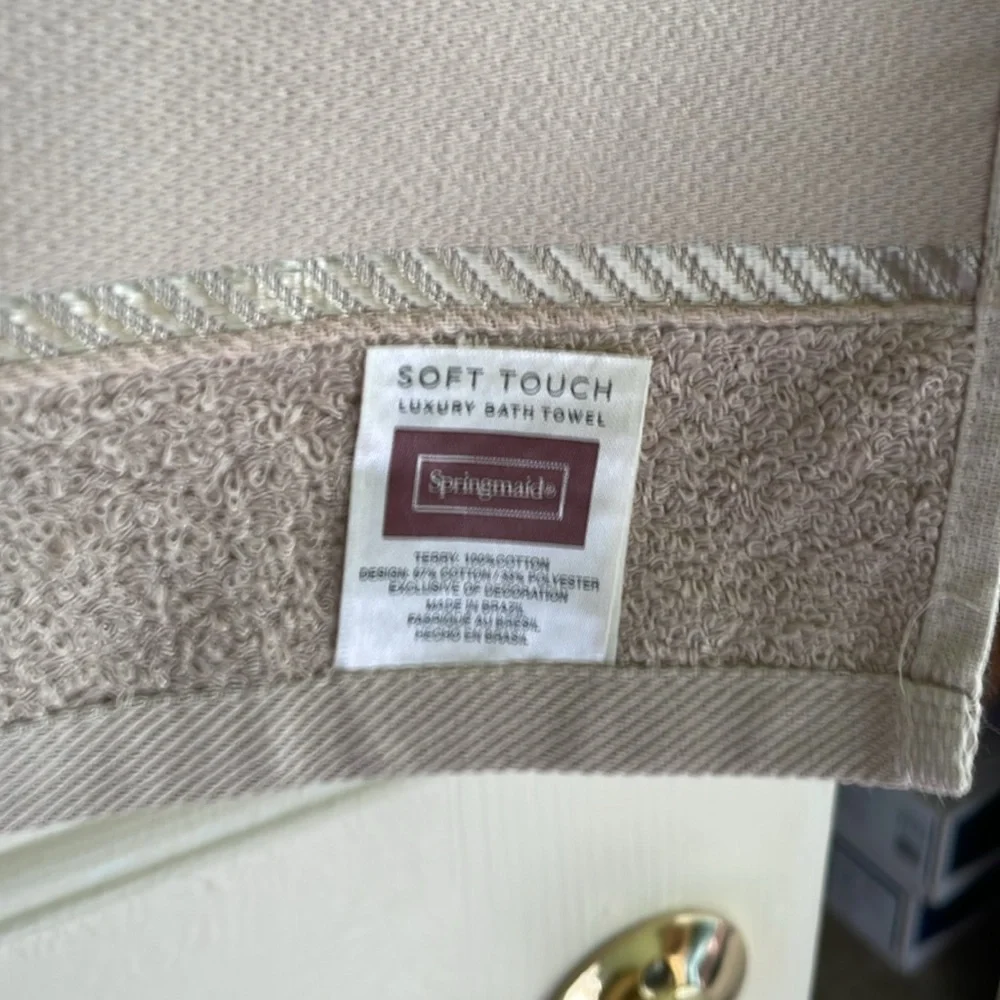 decorative hand towel embroidered at the bottom with floral pattern.